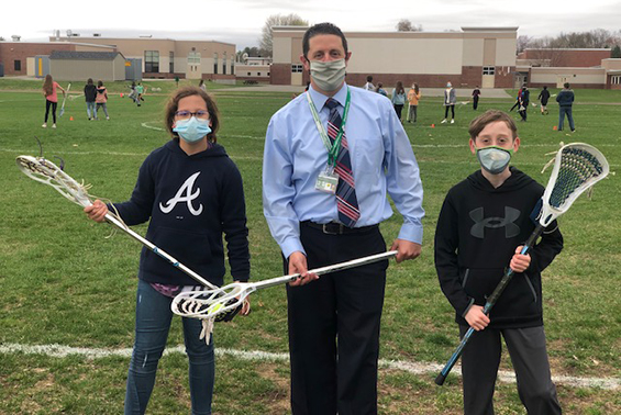 Asst Principal, Mr. Luke joins in on a game of capture the LAX ball in 6th grade PE 