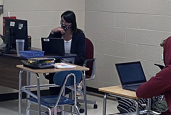 Students in Rachel Karam's high school class study Spanish virtually and in person. 