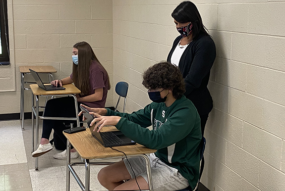 Students in Rachel Karam's high school class study Spanish virtually and in person. 