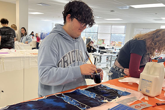 Shen HS student Dane Zenner learns to create colorful, silk scarves as part of the latest project in the two-year program Global Fashion at the Capital Region BOCES.