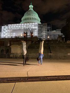 students doing handstand in front of capital