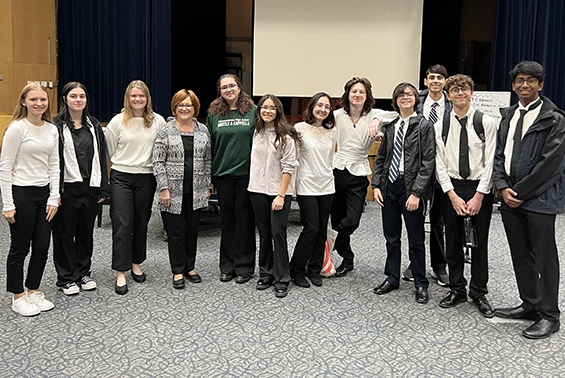 a group of students posing in an auditorium