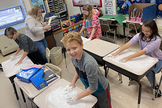 Skano fifth grade students have fun with shaving cream as they practice their sight words kinesthetically. 