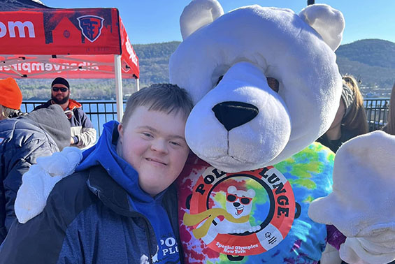 a student with the polar plunge bear