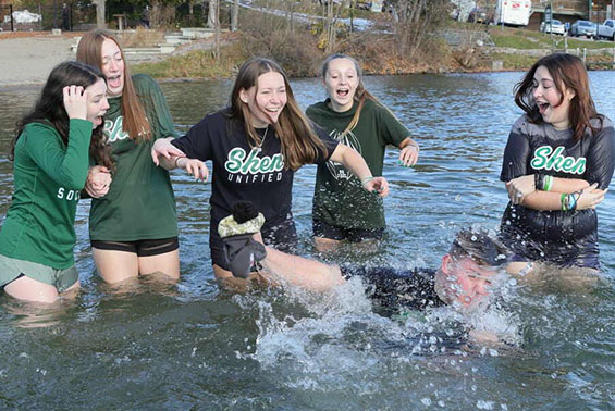 a group of students plunging into the water