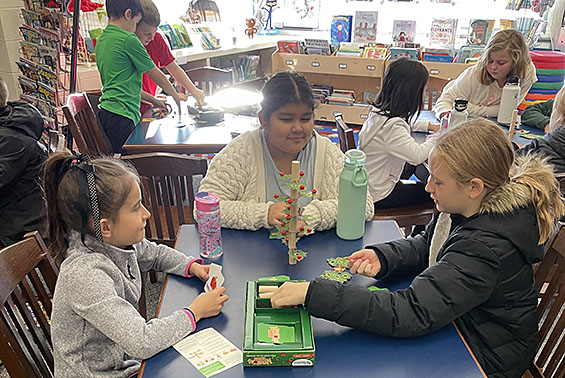 three students playing a game