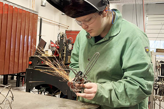 Shenendehowa High School junior Astro Rosenberry grinds a metal sculpture in class at the Capital Region BOCES Career & Technical Education Center – Albany Campus.