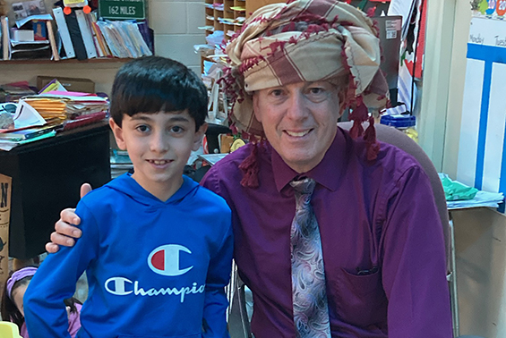 Okte 3rd grader Yaseen gives his teacher, Mr. D'Ambro, a very special gift for Christmas. Mr. D'Ambro was honored to wear the yesh-magh which is a male Arab headdress. 