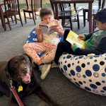 Skano third graders enjoy reading to Kasie, one of Skano’s therapy dogs.